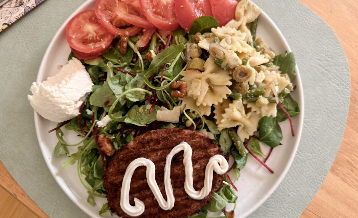 Mache salad with julienned beetroot, sliced tomato, ricotta cheese, walnuts, and leftover pasta